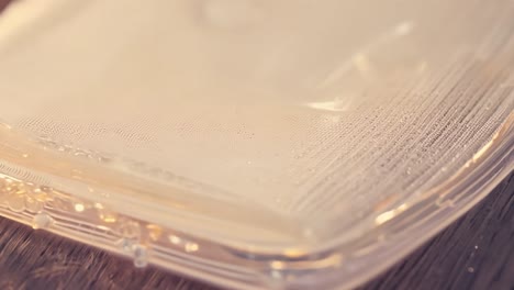 close up of a transparent plastic container lid