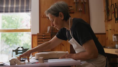 female luthier at work in her workshop