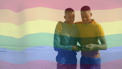 walking on beach, two people with rainbow flag overlay in animation