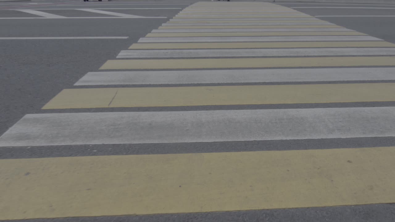 Close up on white and yellow pedestrian crossing in Moscow, Russia, dolly
