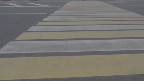 close up on white and yellow pedestrian crossing in moscow, russia, dolly