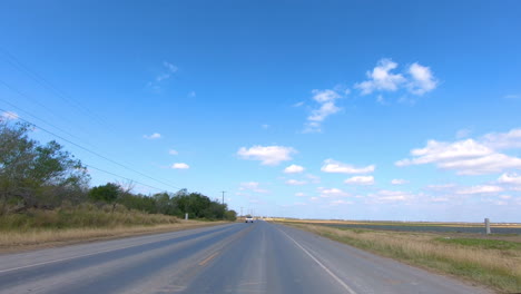 pov driving through rural rio grande valley in southern texas past vegetable fields