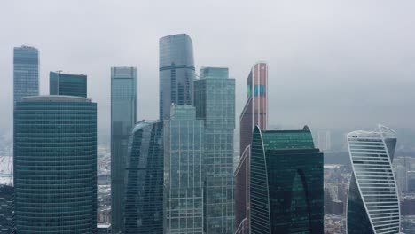 aerial drone shot of moscow city skyscrapers at cloudy winter day