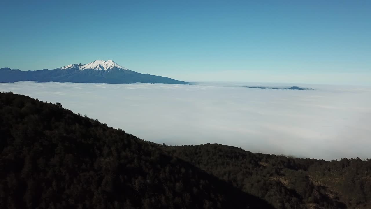Aerial Panorama of Volcanic Region of Chile, Thick Couds in Valley Under Mountain Peaks