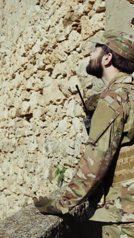 young soldier prays remembering his fallen comrade in the battle