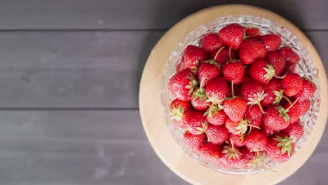 strawberries in a bowl on a wooden background