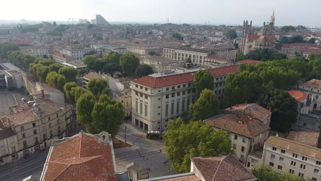 modern tramway with montpellier city ecusson in background. aerial drone france
