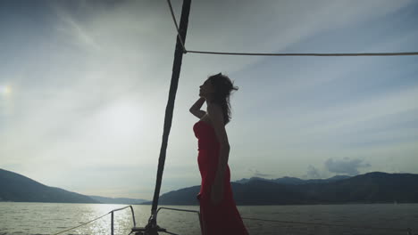 woman in red dress on a yacht at sunset