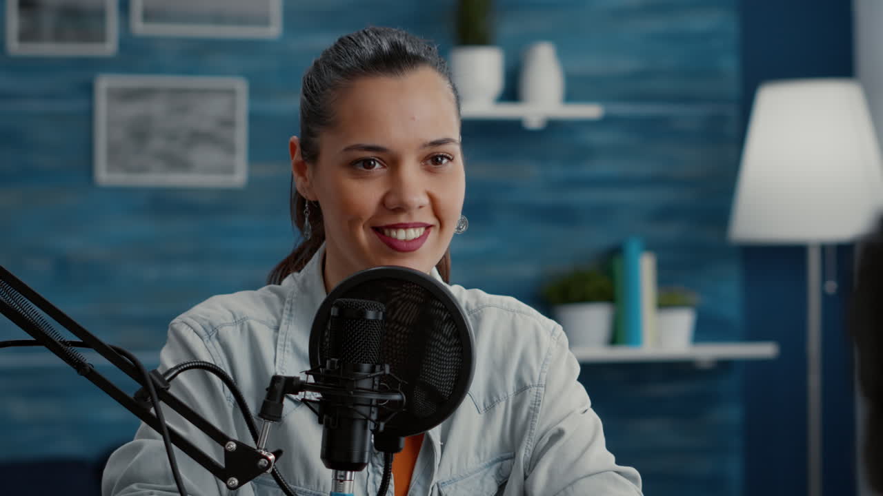 Popular social media influencer sitting at home studio desk while recording vlog
