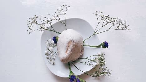 floral arrangement with stone on a plate