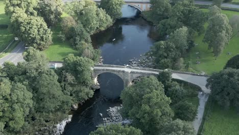 An-aerial-view-of-the-Devil's-Bridge-at-Kirkby-Lonsdale-on-a-summer-evening,-Yorkshire,-England,-UK