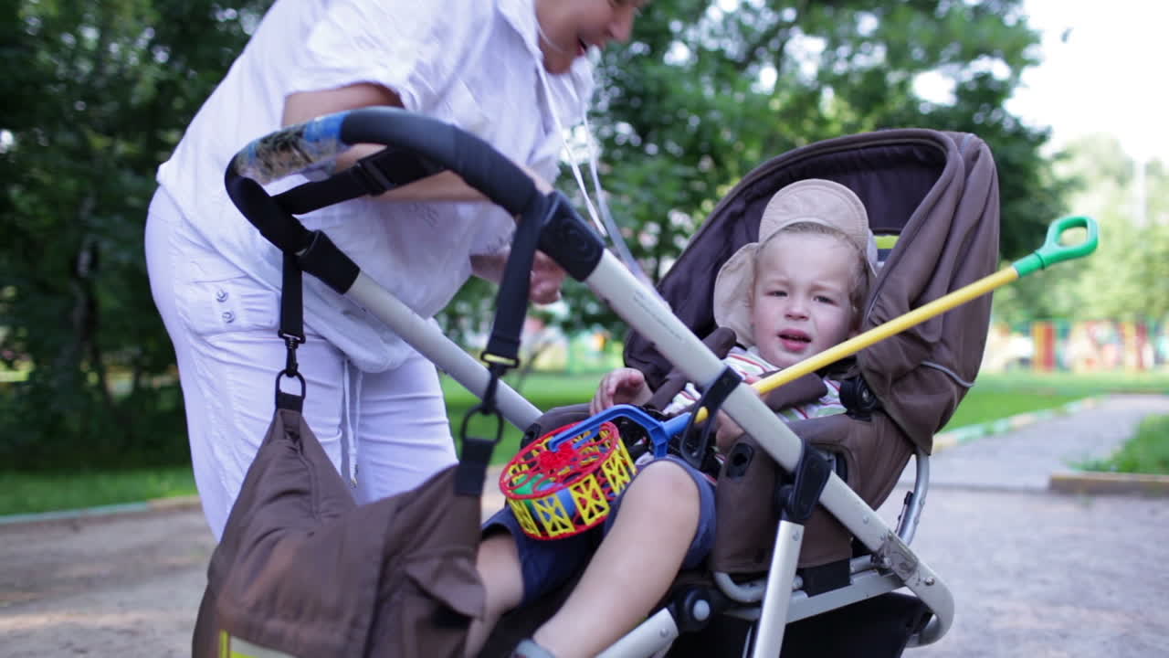 Naughty boy in the buggy with granny