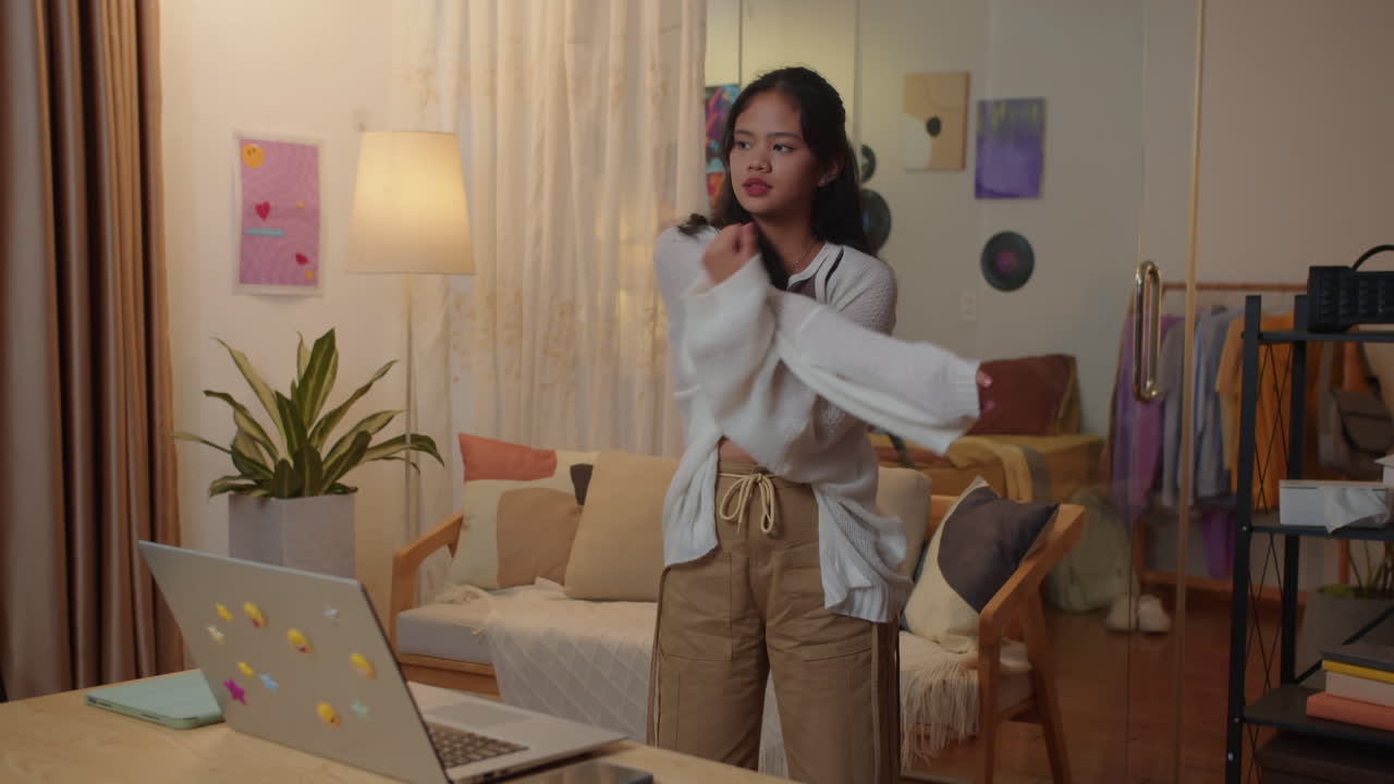 Asian Schoolgirl Warming Up before Webinar Studying from Home