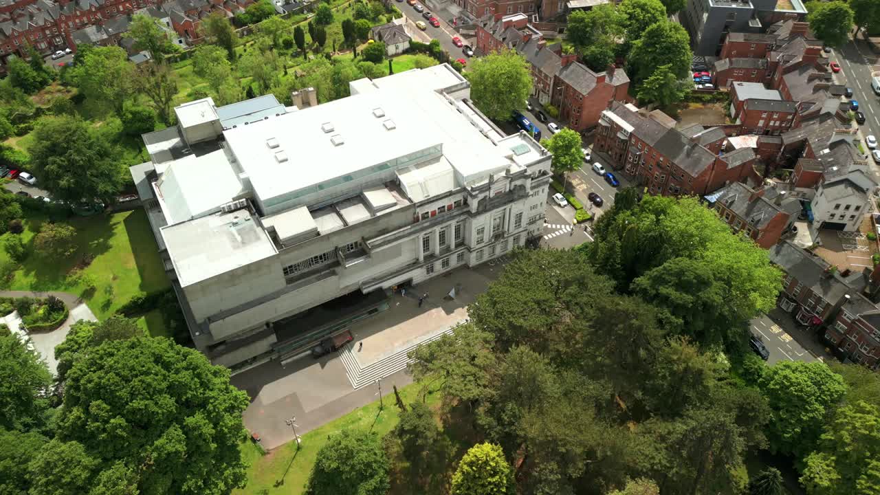 Advancing overhead aerial video of Ulster Museum in Botanic Gardens in Belfast, Northern Ireland on a bright sunny day. Produced in 4K, 60 frames per second and with Rec709 color.