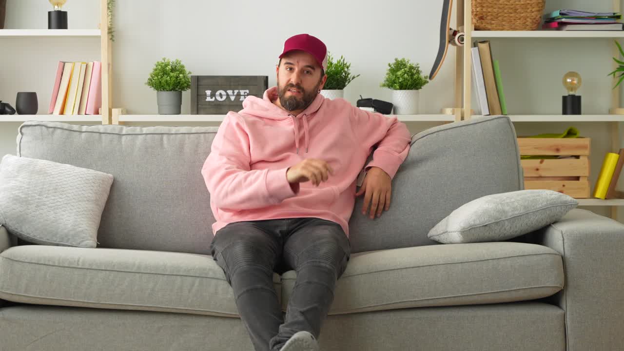 Man sitting on couch in a living room