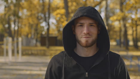 man in a hoodie in an autumn park