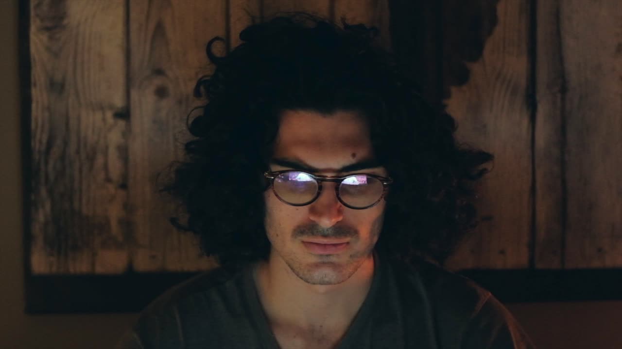 Serious Man Home Office in Night Work Meeting