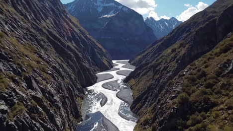 a winding river flowing through a deep mountain valley