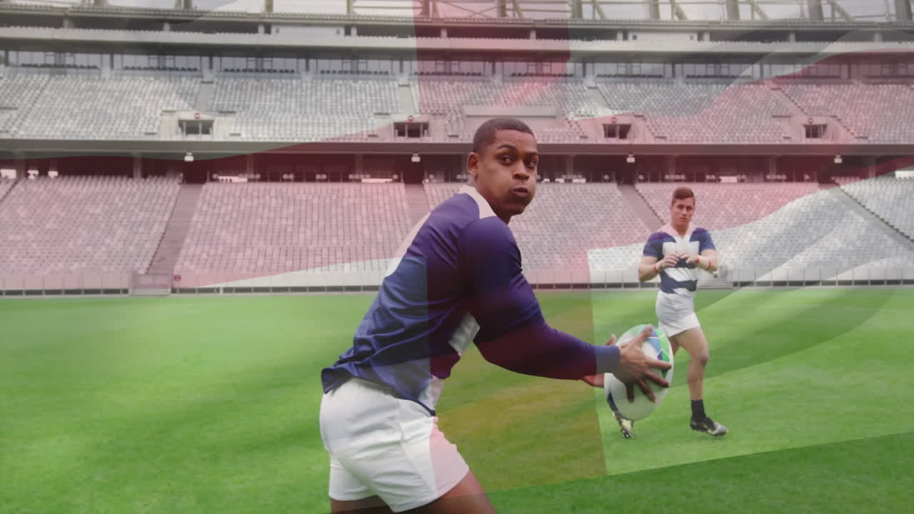 Praticando rugby, jogadores em campo verde em grande estádio vazio com animação