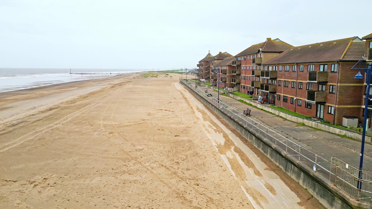 Witness Mablethorpe's scenic beauty through aerial perspectives, an East Coast gem in Lincolnshire, with beach huts, sandy beaches, and the bustling amusement parks drawing tourists