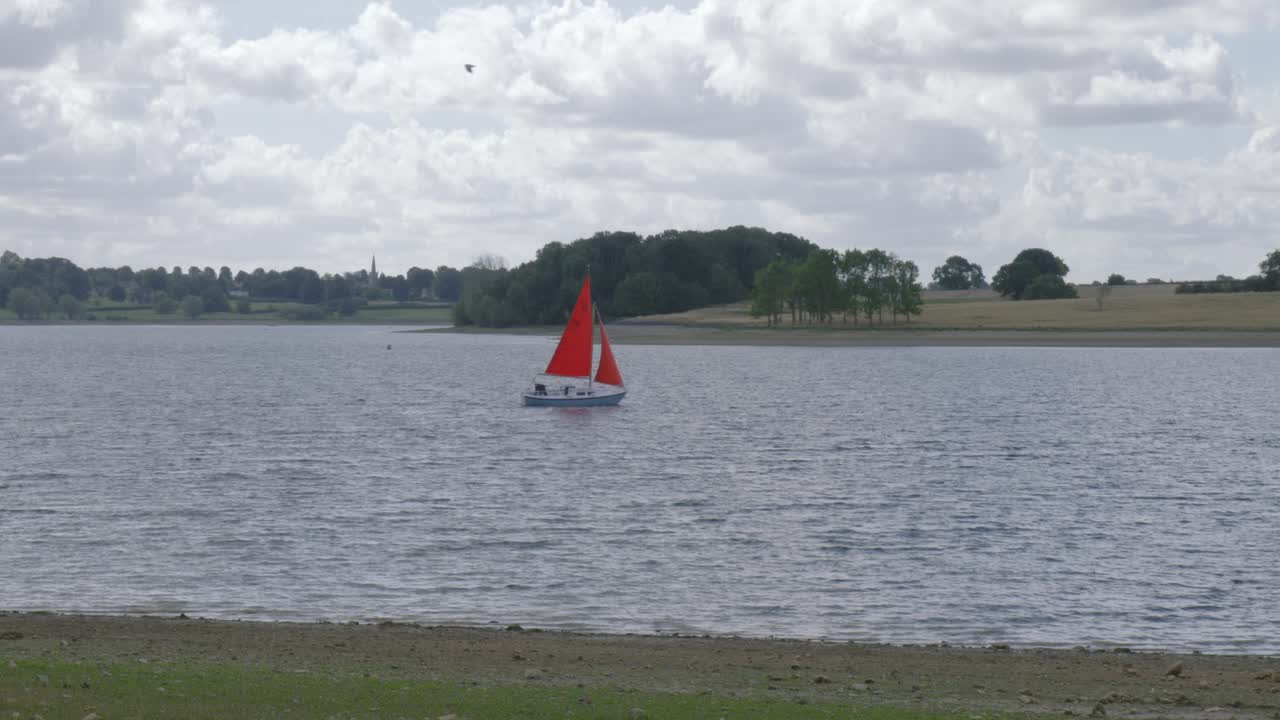 Sailing boat water sport leisure on Rutland man-made reservoir in England