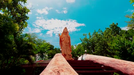 Looking-up-at-a-large-golden-Kwan-Im-statue-at-Wat-Samphran-Temple-Amhoe-Sam-Phran-province-Thailand