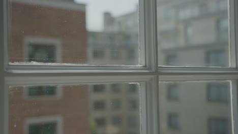 a 5k shot of london buildings through a window frame.