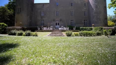 slow establishing shot of a chateau garden in the south of france through a metal ring