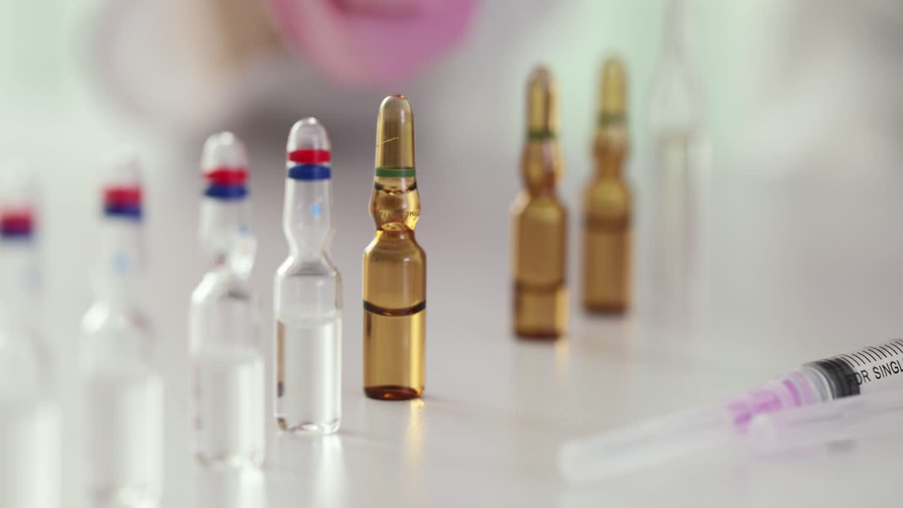 Ampoules and Syringe in a Medical Setting