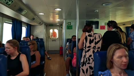 people seated and interacting on a ferry