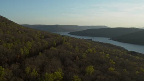 Aerial-footage-flying-sideways-over-a-forest-revealing-the-Tennessee-River-and-Nickajack-Lake-in-the-background