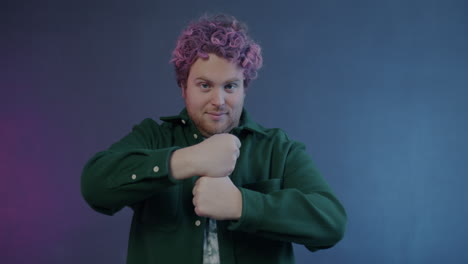 man with pink curly hair posing