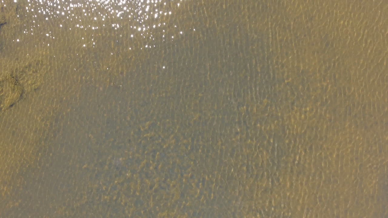 Sun reflection over water ponds by drone. Close up aerial salt marshes France