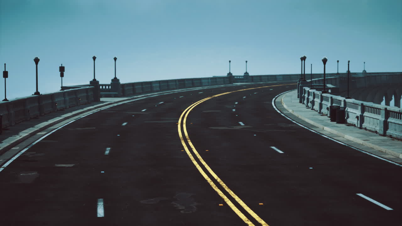 Curved road along coastline enveloped in fog on a quiet morning