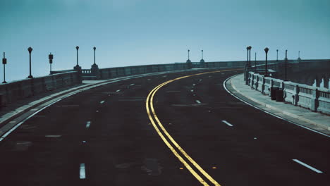 curved road along coastline enveloped in fog on a quiet morning