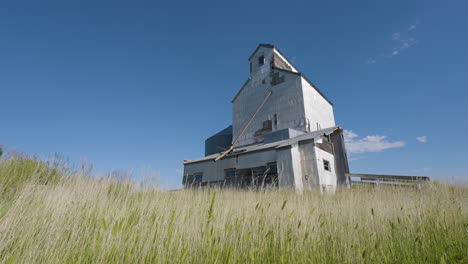 old abandoned grain elevator in a field