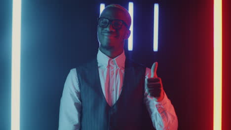 man giving thumbs up in neon light