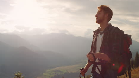 energetic hiker walk nature on mountains landscape. hipster using trekking poles