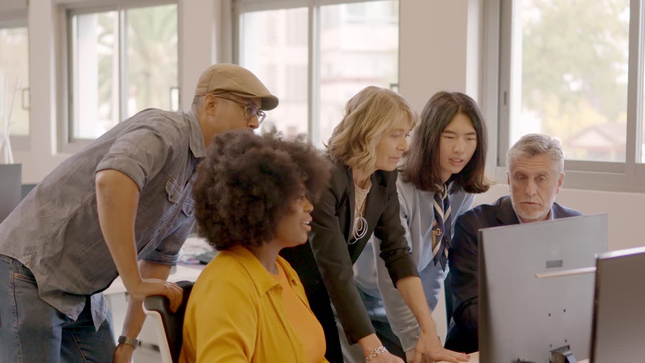 Work team in a meeting in front of a computer