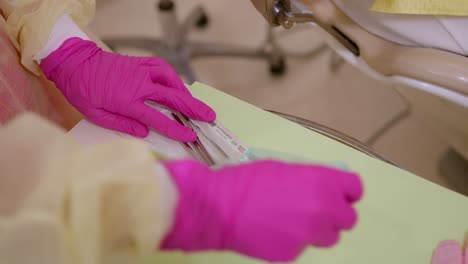 close up of dentist opening the autoclaved bag and removing orthodontic material