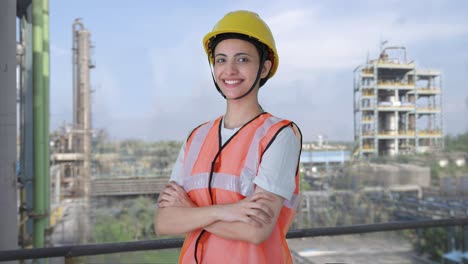 portrait of happy indian female construction worker standing crossed hands