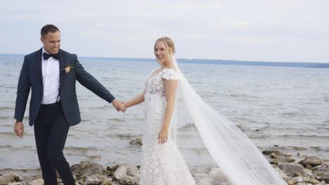 bride and groom walk on beach