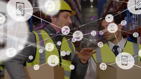 Animation-of-network-of-connections-with-icons-over-two-caucasian-warehouse-workers