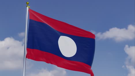 Flag-Of-Laos-Moving-In-The-Wind-With-A-Clear-Blue-Sky-In-The-Background,-Clouds-Slowly-Moving,-Flagpole,-Slow-Motion