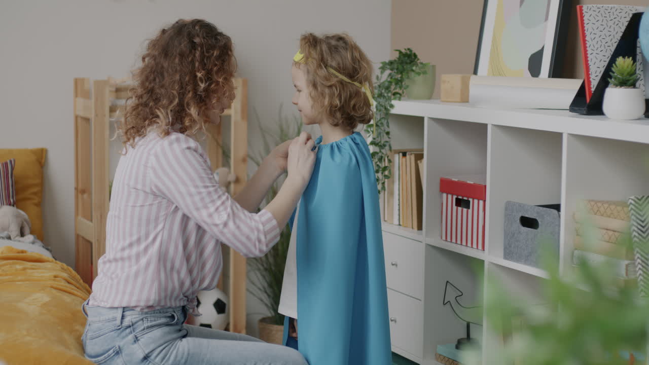 Mother and Daughter Dressing Up as Superheroes