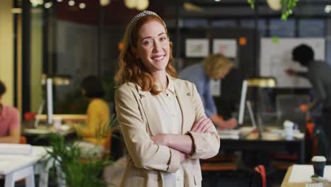 portrait of happy caucasian businesswoman looking at camera at office