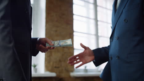 businessman giving money partner at office meeting close up. man receiving bribe