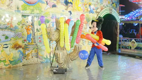 mickey mouse balloon artist at a carnival