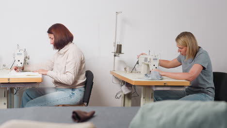 elegant female seamstress stitching cloth pattern in workshop setting, focusing on intricate details, ensuring professional quality, demonstrating flair, producing fashionable pieces