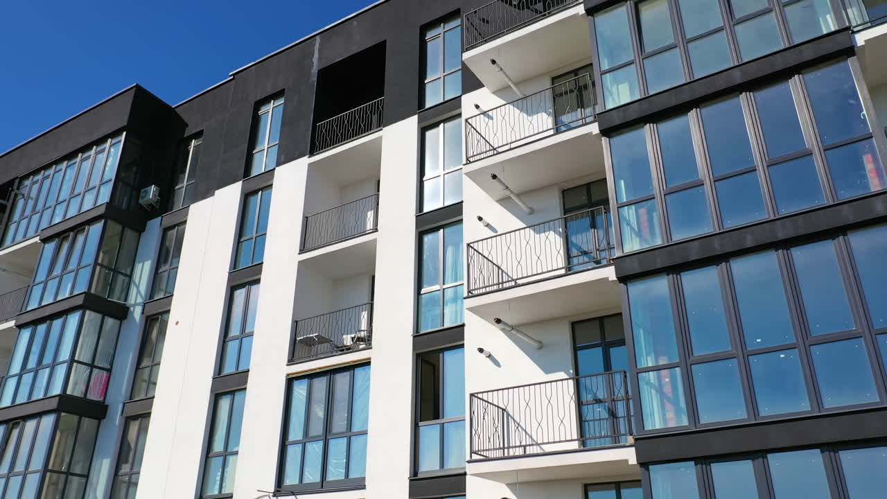 Residential area with high apartment buildings. Aerial view of tall residential apartment building with many windows and balconies